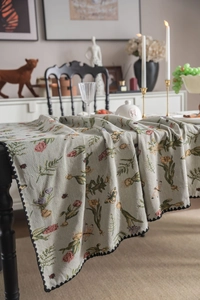 Close-up of French vintage tablecloth with floral embroidery and black wavy lace edge