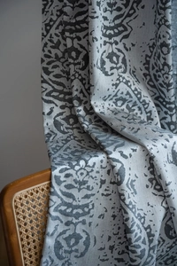 Close-up of grey vintage damask jacquard curtain fabric with woven texture on wooden chair
