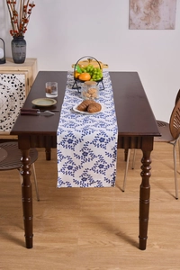 Detail of French floral table runner featuring blue patterns on beige cotton linen fabric