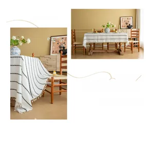Detailed close-up of embroidered black geometric lines and tassel edges on white cotton tablecloth
