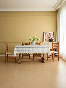 Detail of cream rectangular tablecloth with black geometric embroidery and tassels