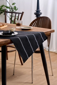 Macro shot of Nordic style black and white striped cotton linen napkins on wooden table