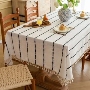 Rectangular cream tablecloth with black wave stripes and elegant tassel edges