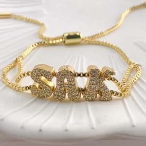 Golden double-hole slider bracelet with SAK letters and sparkling zircon stones inlay