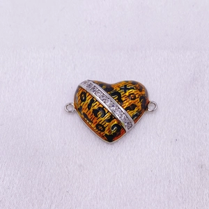 Detalle macro del conector de corazón con estampado de leopardo y piedras de circón