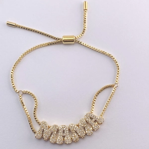 Detail of adjustable gold-plated box chain bracelet featuring a CZ pavé MAMA charm