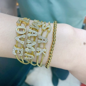 Gold-plated letter charm bracelets with LOVE and SUNSHINE pavé zircon detailing