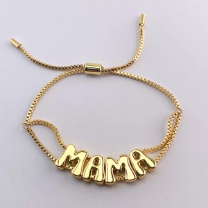 Detailed view of golden MAMA adjustable bracelet with box chain and smooth finish