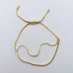 Detail view of 18k gold plated box chain bracelet with adjustable slider clasp feature