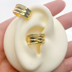 Detail of gold-plated ear cuff with pavé zircon stones on a silicone model ear