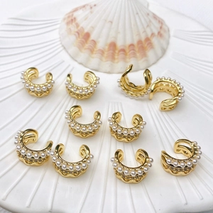 Detailed view of 18K gold plated double C ear cuff with acrylic pearls and crystals