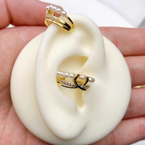 Detailed close-up of 18K gold plated double-layer C-shape ear cuffs with white pearls