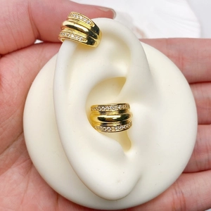 Detail of 18K gold plated double C-shaped ear cuffs featuring rows of sparkling cubic zirconia