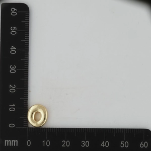 Measurement of 12mm gold DIY jewelry charm with ruler scale on white background