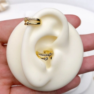 Detail of gold double-layer C-shape ear clips with zircon on a silicone ear model