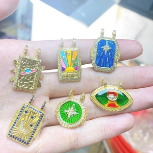 Bohemian tarot style gold pendants with colorful enamel sun, star, and moon designs