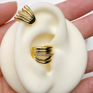 Detail of 18K gold plated double C-shape ear cuffs with pavé crystals on a faux ear model