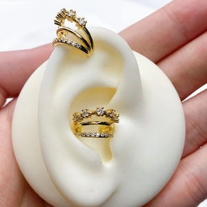 Detail of gold-plated triple-layer ear cuff featuring sparkling white zircon stone clusters