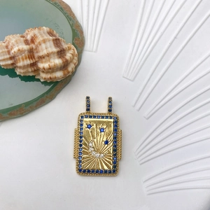 Detail of gold sun and moon tarot pendant with blue zircons and twin hanging loops