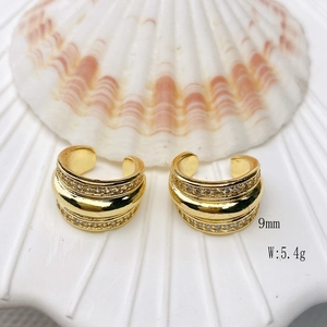Detail view of 9mm C-shaped 18K gold plated ear cuff with pavé crystals on a shell