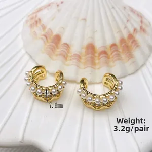 Detailed macro view of 18K gold plated double C-shape clip earrings with acrylic pearls