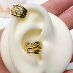 Detailed macro view of gold-plated U-shaped ear cuffs with micro-pave cubic zirconia accents