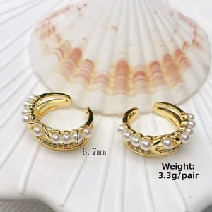 Detailed view of 18K gold plated C-shaped ear cuffs with pearls and crystal inlay