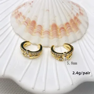 Detail view of double-layer C-shape gold ear cuffs measuring 5.8mm with acrylic beads