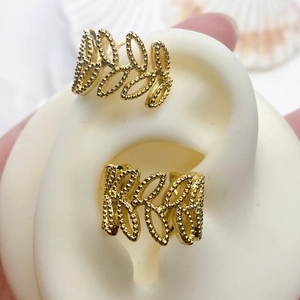 Detail of 18K gold plated wavy geometric ear cuff with intricate milgrain beaded edges