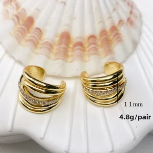 Detailed macro of golden multi-layer ear cuff with zircons, dimensions 11mm and 4.8g weight