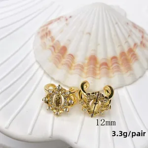 Detail view of 12mm 18K gold plated virgin Mary earrings with white zircons
