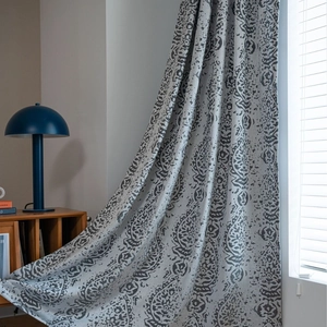 Close-up of brown paisley damascus pattern on semi-sheer fabric window curtains