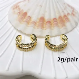 Detailed close-up of gold double-row micro-pave ear cuffs with 5mm width and 2g weight