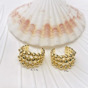 Detail of gold beaded wavy C-shape earrings with dimensions 9.3mm width and 3.8g weight