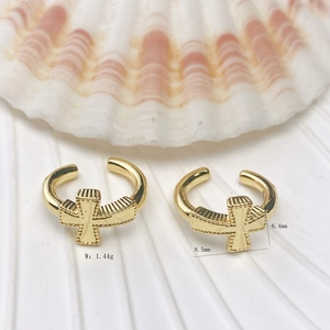 Detail showing dimensions and 18K gold plated cross ear cuff on white shell background