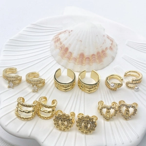 Golden ear cuff and stud set featuring zircon pendants and heart embossing on shell