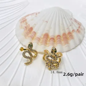 Detail of snake-shaped ear cuffs in 18K gold plated copper with white and green zircons