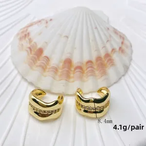 Close-up of gold double-layer C-shaped ear cuffs with micro-inlaid zircons and wavy edges