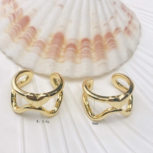 Detailed macro view of 18K gold-plated heart wave ear cuff measuring 9mm in height
