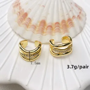Detail view of gold-plated triple layer ear cuff with white zircon stones, 7.5mm width