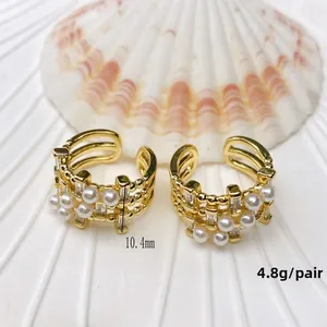 Detail of gold U-shaped ear cuff featuring white pearls and zircon accents, 10.4mm size