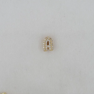 Macro shot of gold bubble letter A pendant with full cubic zirconia pave setting