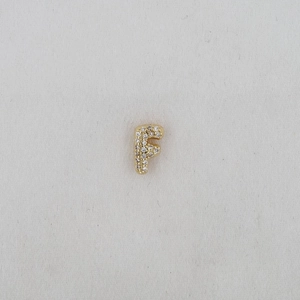 Macro shot of gold-plated puffy letter F charm with micro-pave white zircon stones