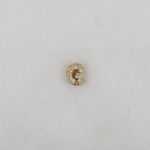Macro shot of gold letter G balloon charm with pavé cubic zirconia for DIY bracelets