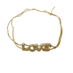 Gold-plated double-layer necklace with crystal pavé LOVE letter pendant on white background