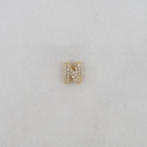 Detailed macro view of gold-plated balloon letter N pendant with pavé zircon stones