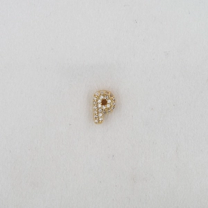 Macro shot of gold-plated balloon letter P pendant encrusted with sparkling zircon stones