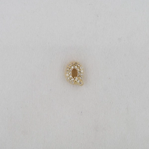 Detailed close-up of a gold-plated letter Q pendant with white cubic zirconia stones