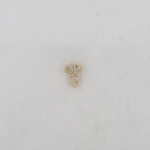Macro shot of gold-plated T-shaped letter charm with sparkling cubic zirconia stones