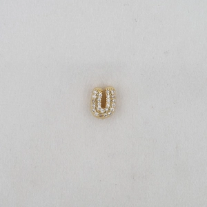 Macro shot of 18k gold plated letter U charm featuring micro-paved white zircon stones